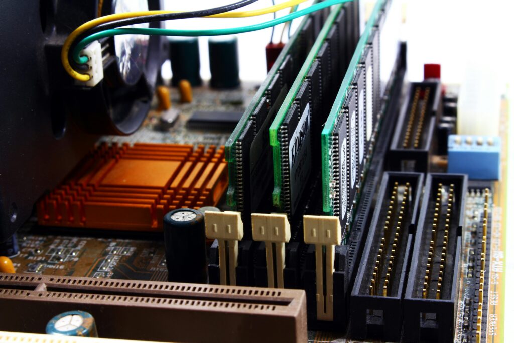 pexels-photo-2588757-2588757 Detailed view of computer motherboard featuring RAM, chipset, and wiring.